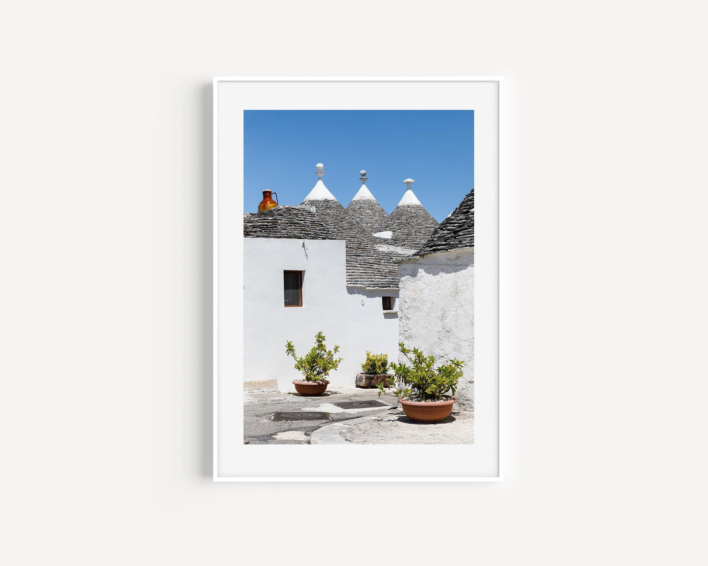 Vertical photo of trulli rooftops and white walls in Alberobello, Italy – Mediterranean architecture travel print