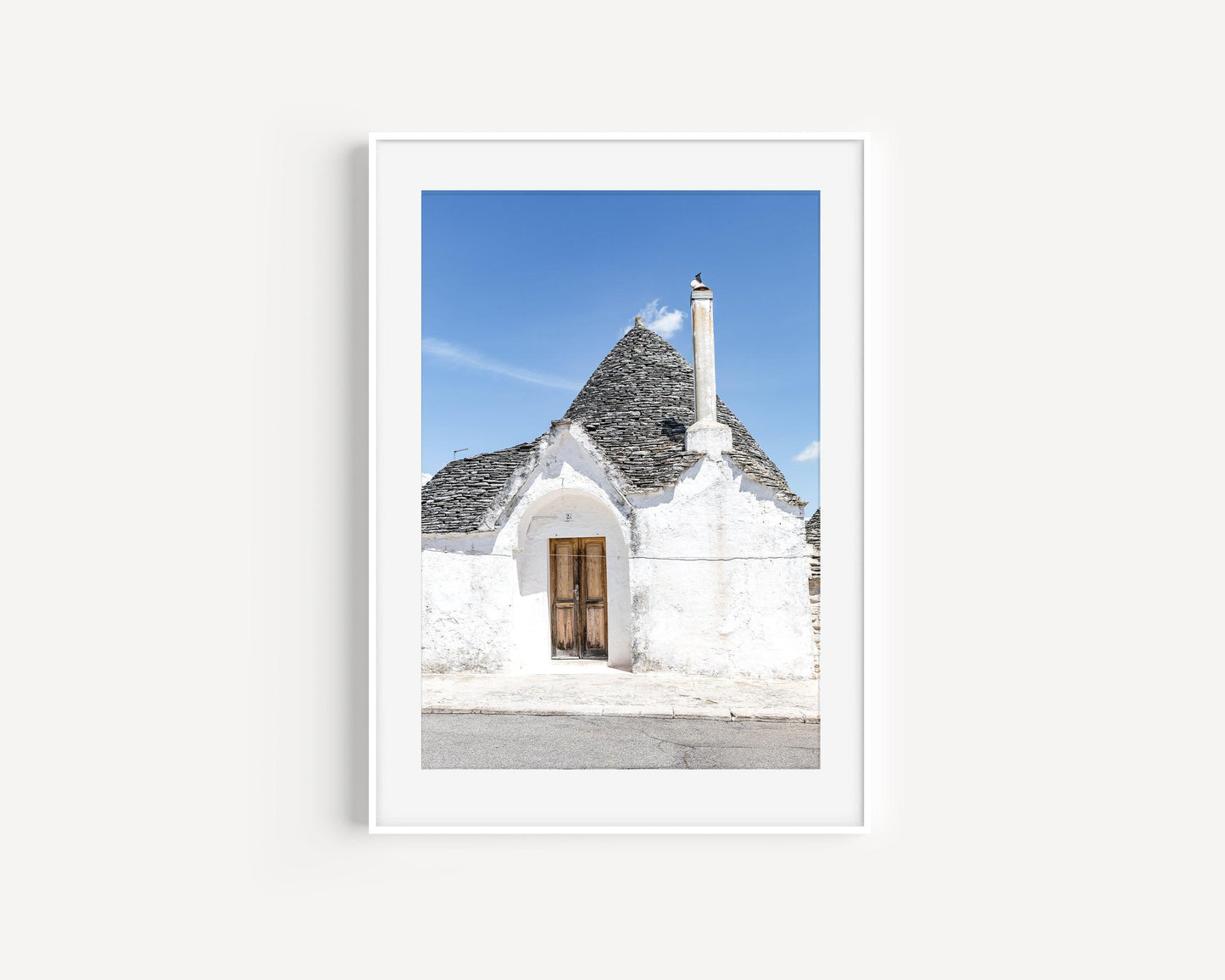 Vertical photo of trullo doorway and rooftop in Alberobello, Italy with stucco walls and blue sky – Mediterranean wall art