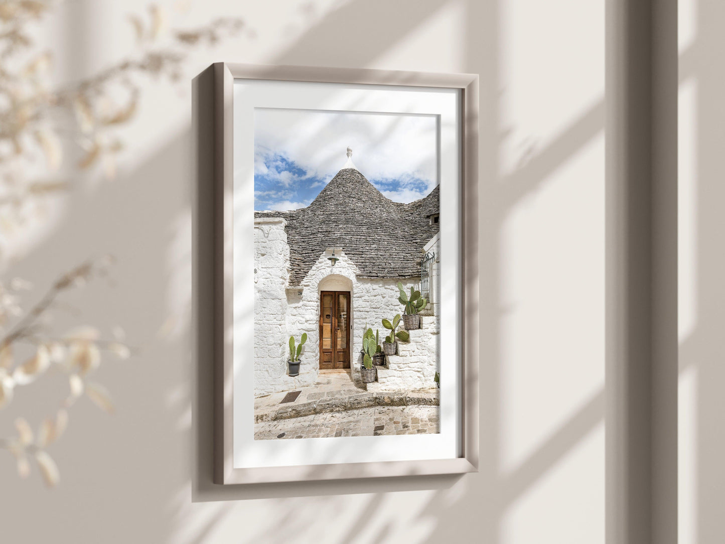 Vertical photo of trullo house in Alberobello, Italy with potted cactus and textured white stone walls – Mediterranean architectural print