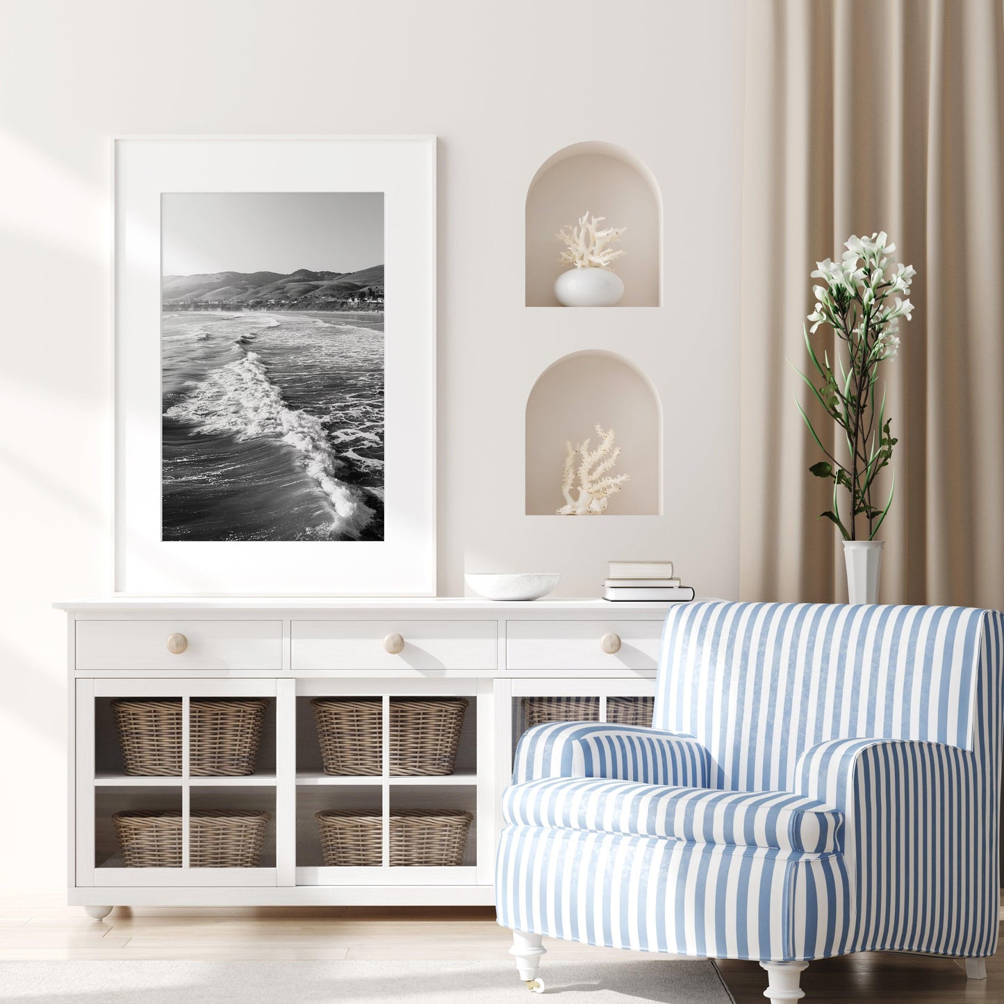 Vertical black and white photo of California ocean waves with sunlight on the surface and distant hills