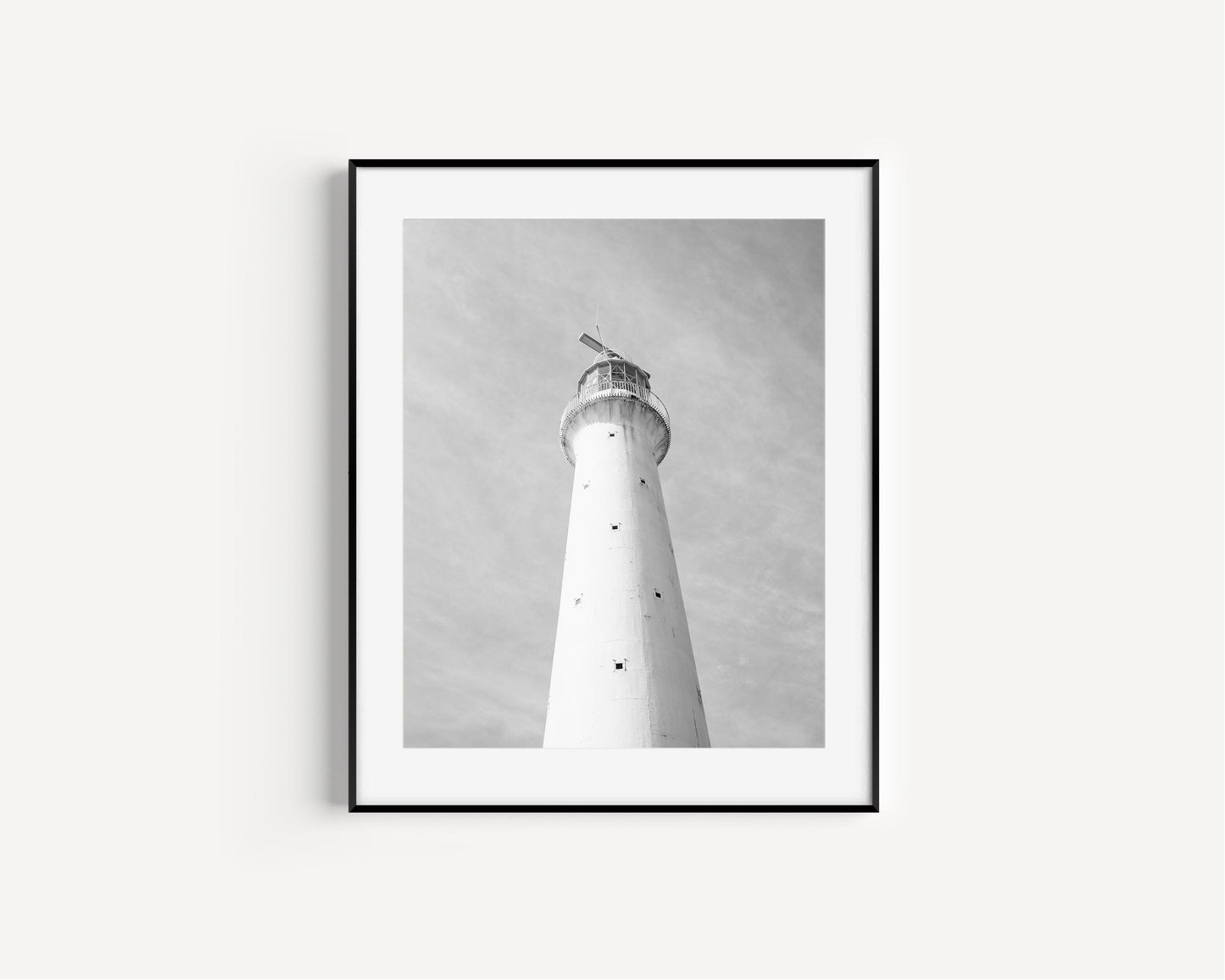 Black and white photo of Gibbs Hill Lighthouse in Bermuda taken from a low angle