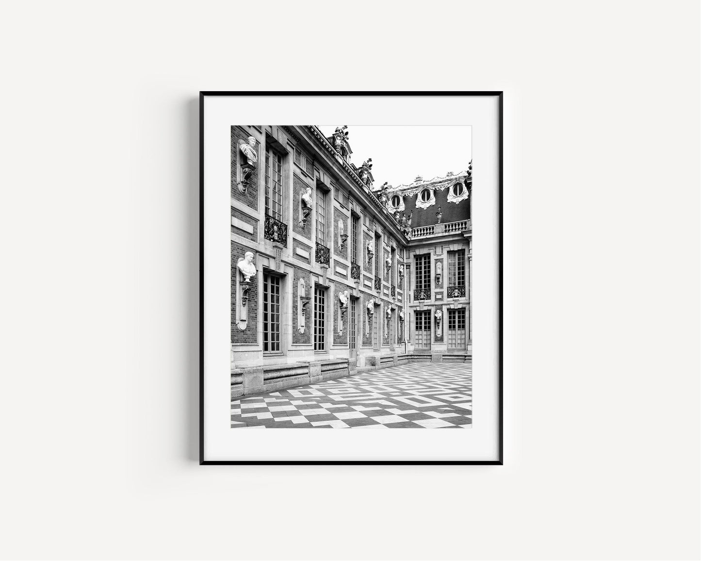 Palace of Versailles captured in black and white photography, showcasing its historic grandeur.