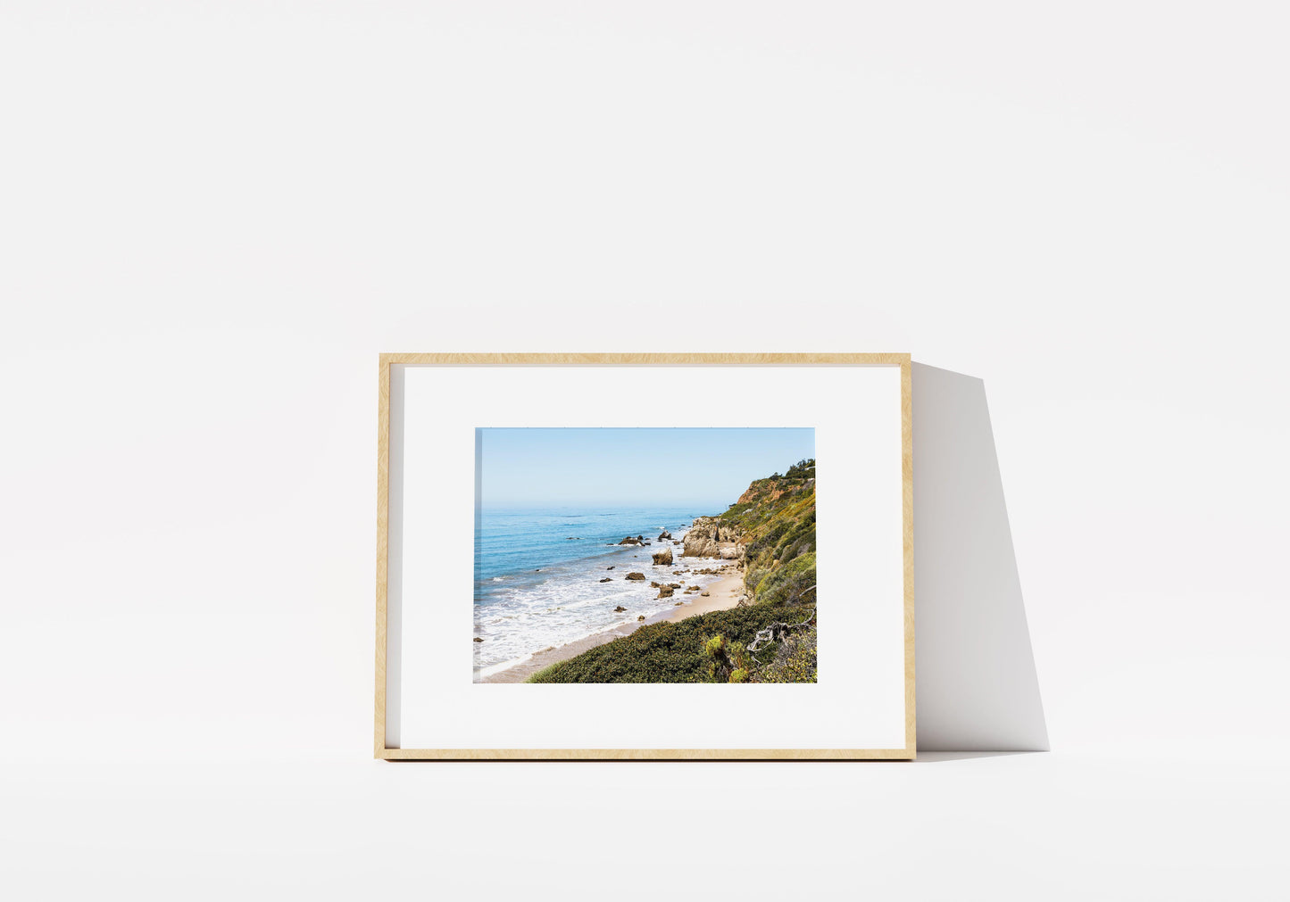 Horizontal coastal photo of El Matador State Beach in Malibu with cliffs, rocks, and ocean waves