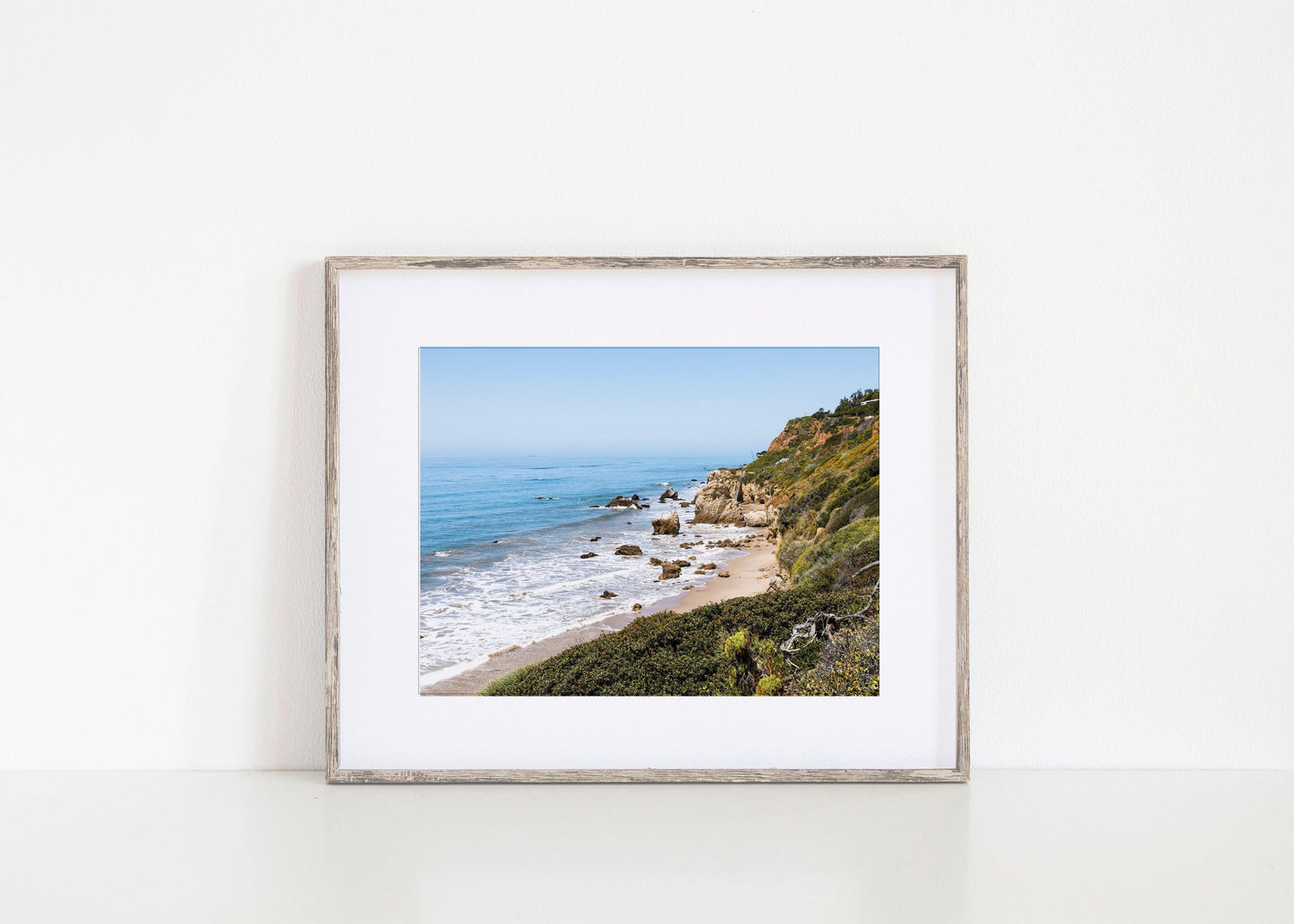 Horizontal coastal photo of El Matador State Beach in Malibu with cliffs, rocks, and ocean waves