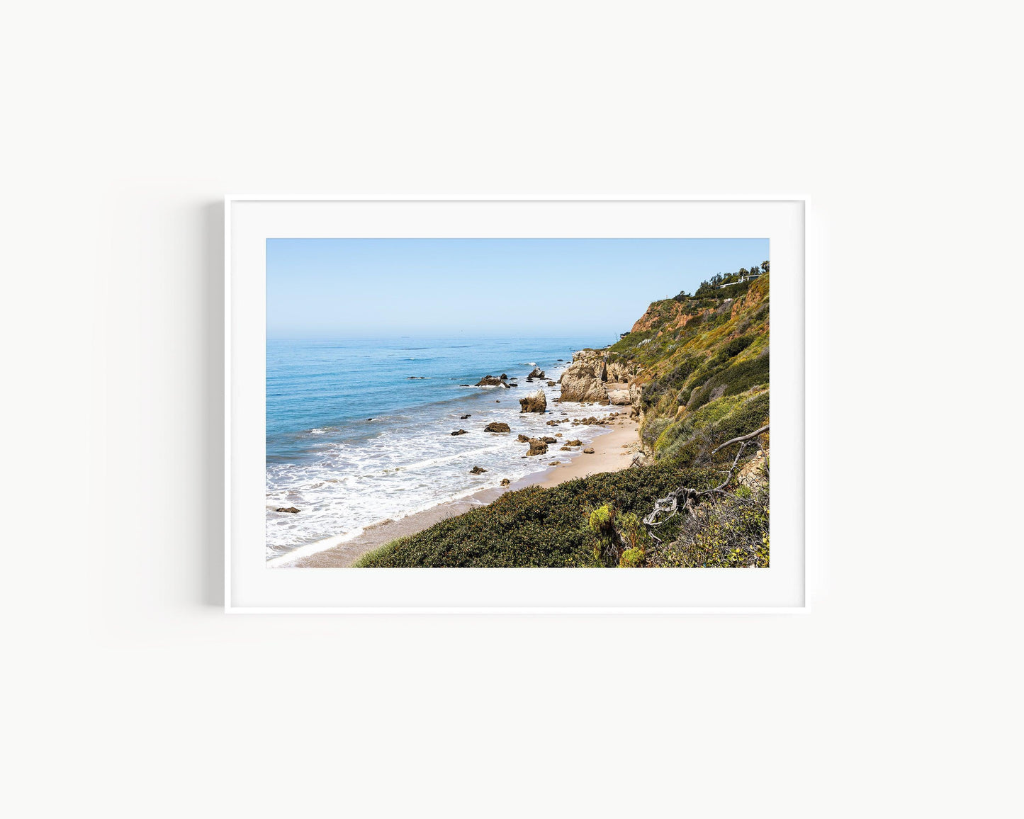 Horizontal coastal photo of El Matador State Beach in Malibu with cliffs, rocks, and ocean waves