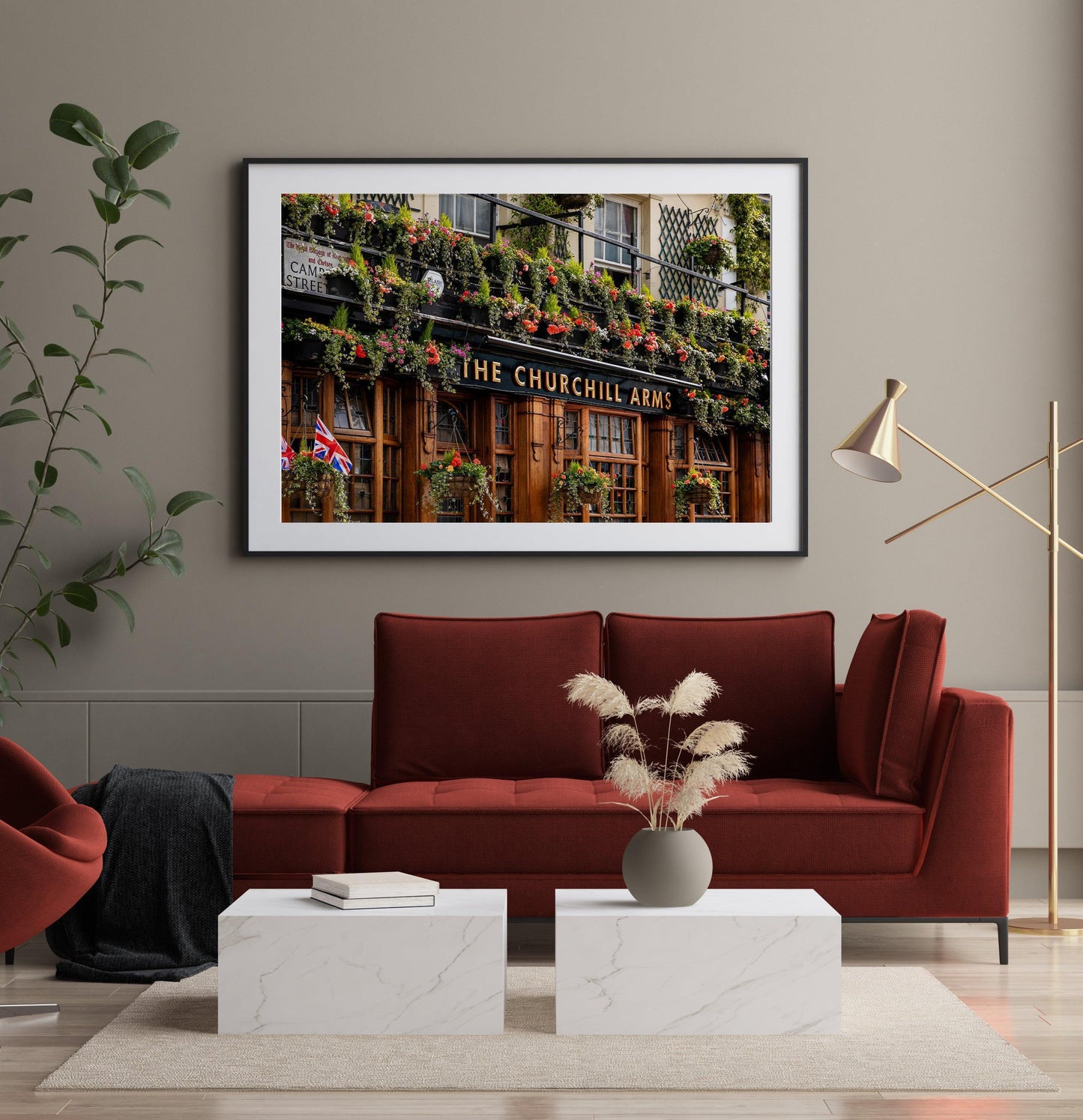 Color photo of The Churchill Arms pub in Notting Hill, London, with hanging flowers and British flag