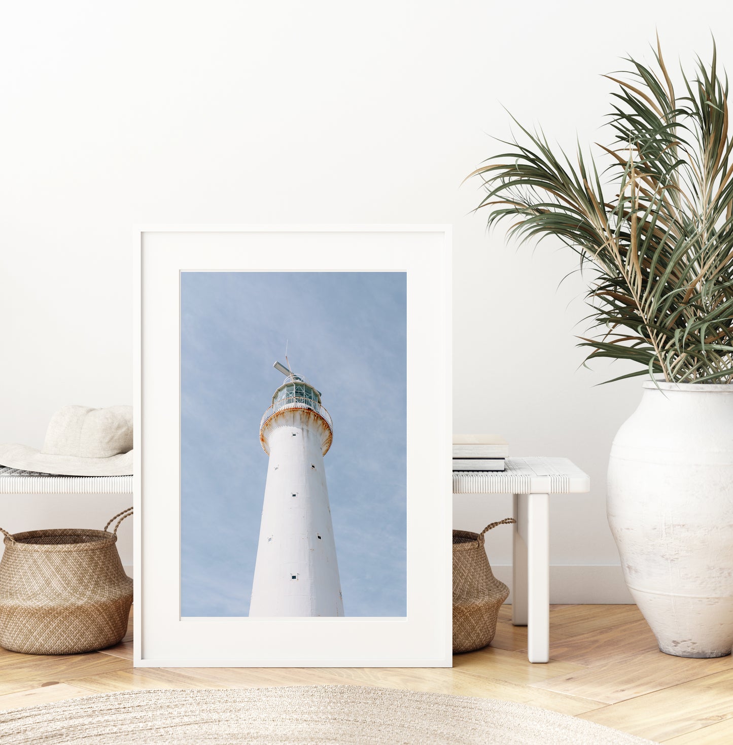 Vertical photo of Gibbs Hill Lighthouse in Bermuda against a soft blue sky