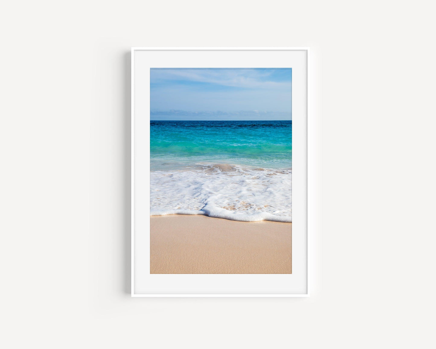 Ocean waves washing onto Bermuda’s pink sand beach with turquoise water.