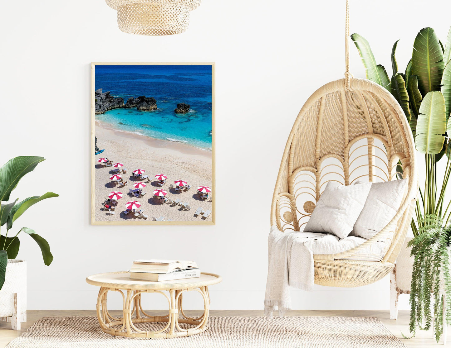 Pink and white beach umbrellas by the ocean.
