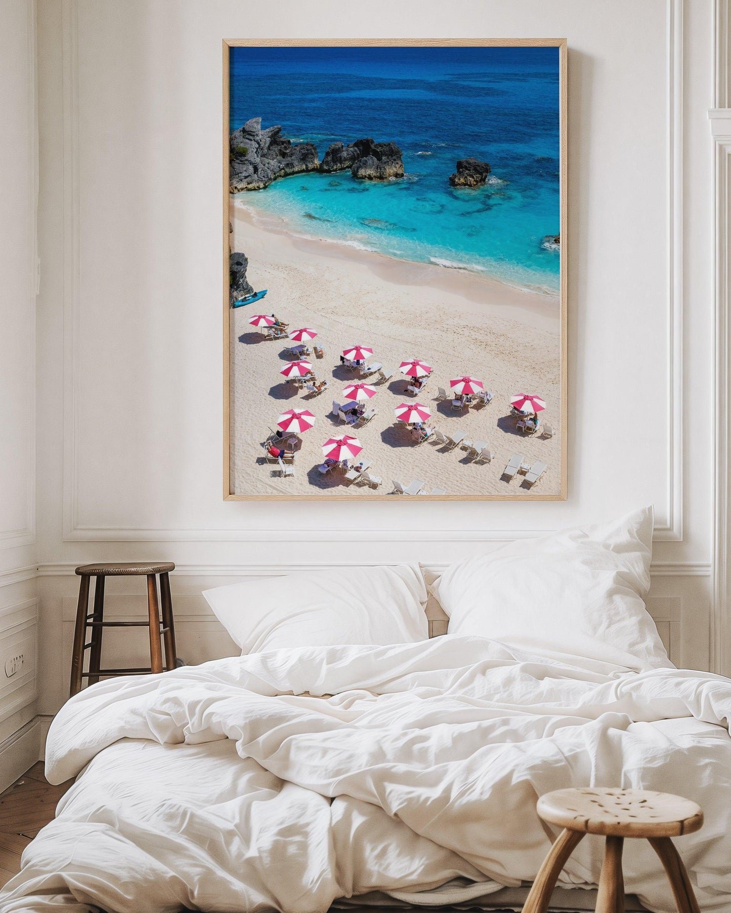 Pink and white beach umbrellas by the ocean.