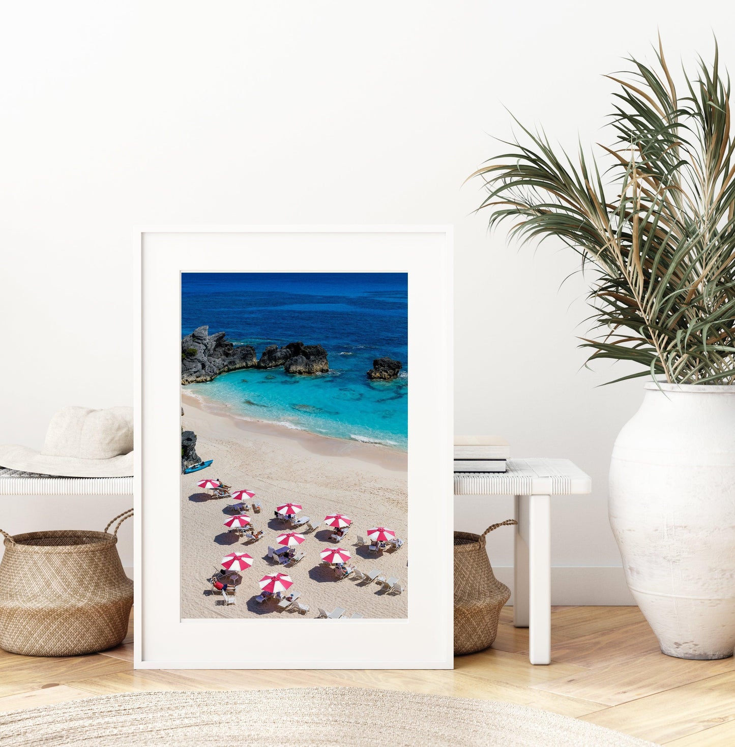 Pink and white beach umbrellas by the ocean.