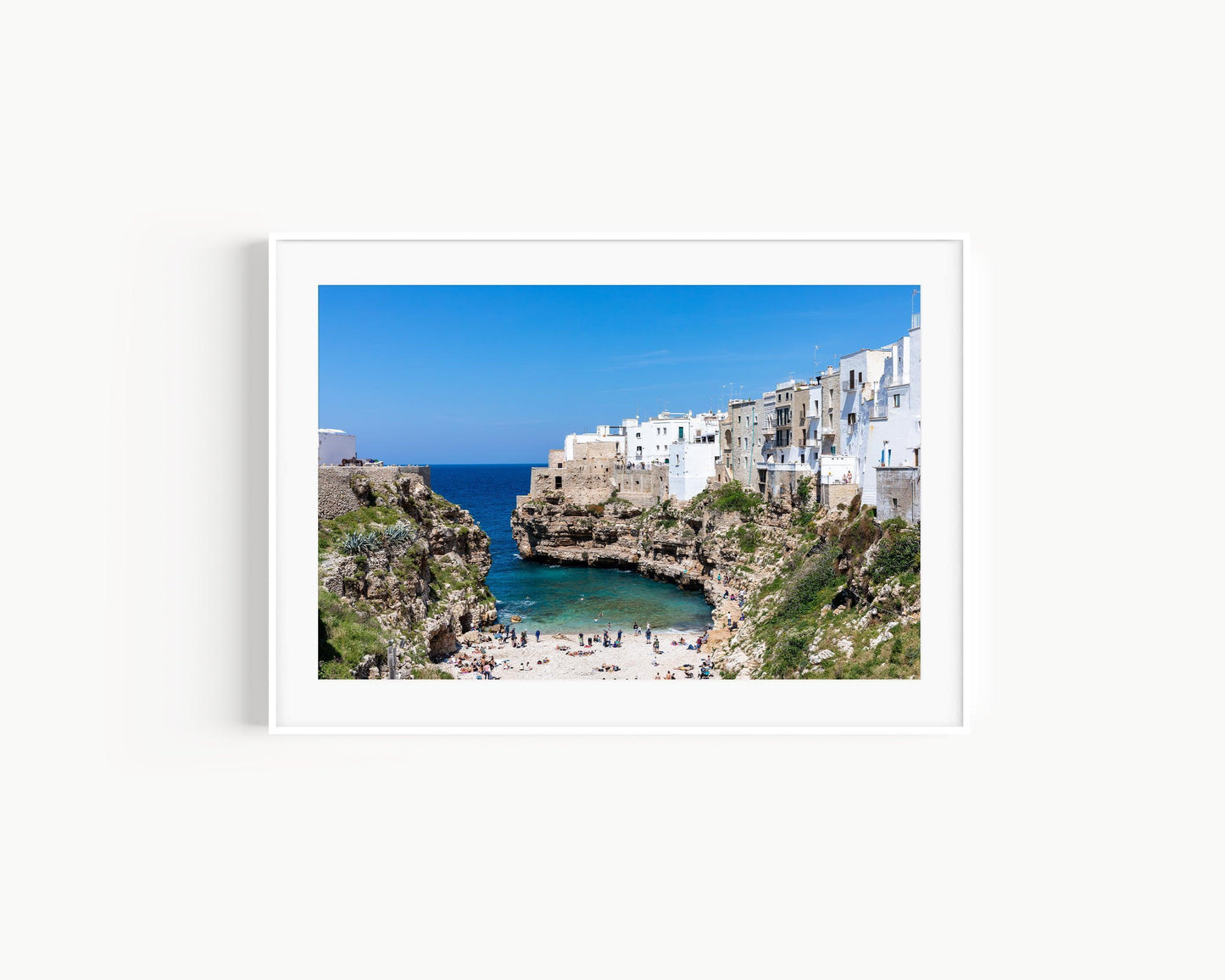 Turquoise waters and limestone cliffs in Polignano a Mare, Italy.