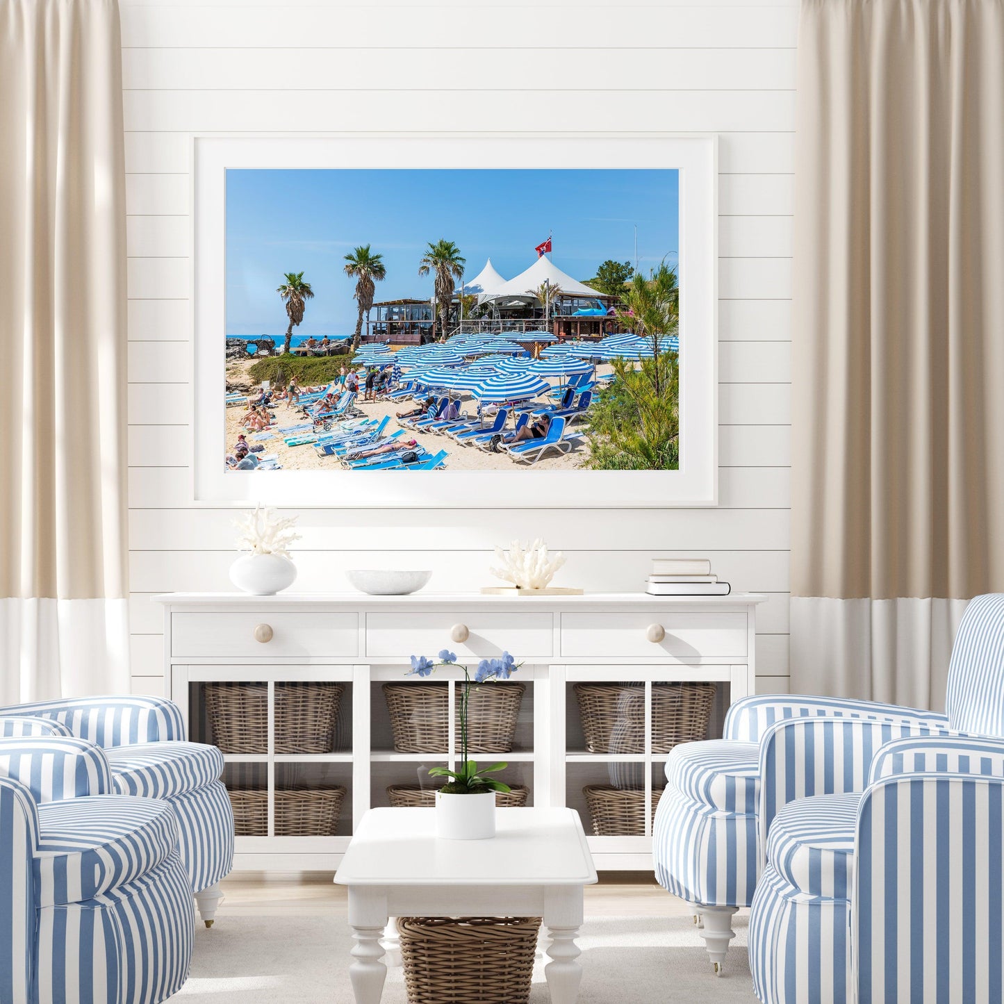 Blue beach umbrellas along the shoreline of Tobacco Bay, Bermuda, with turquoise waters in the background.
