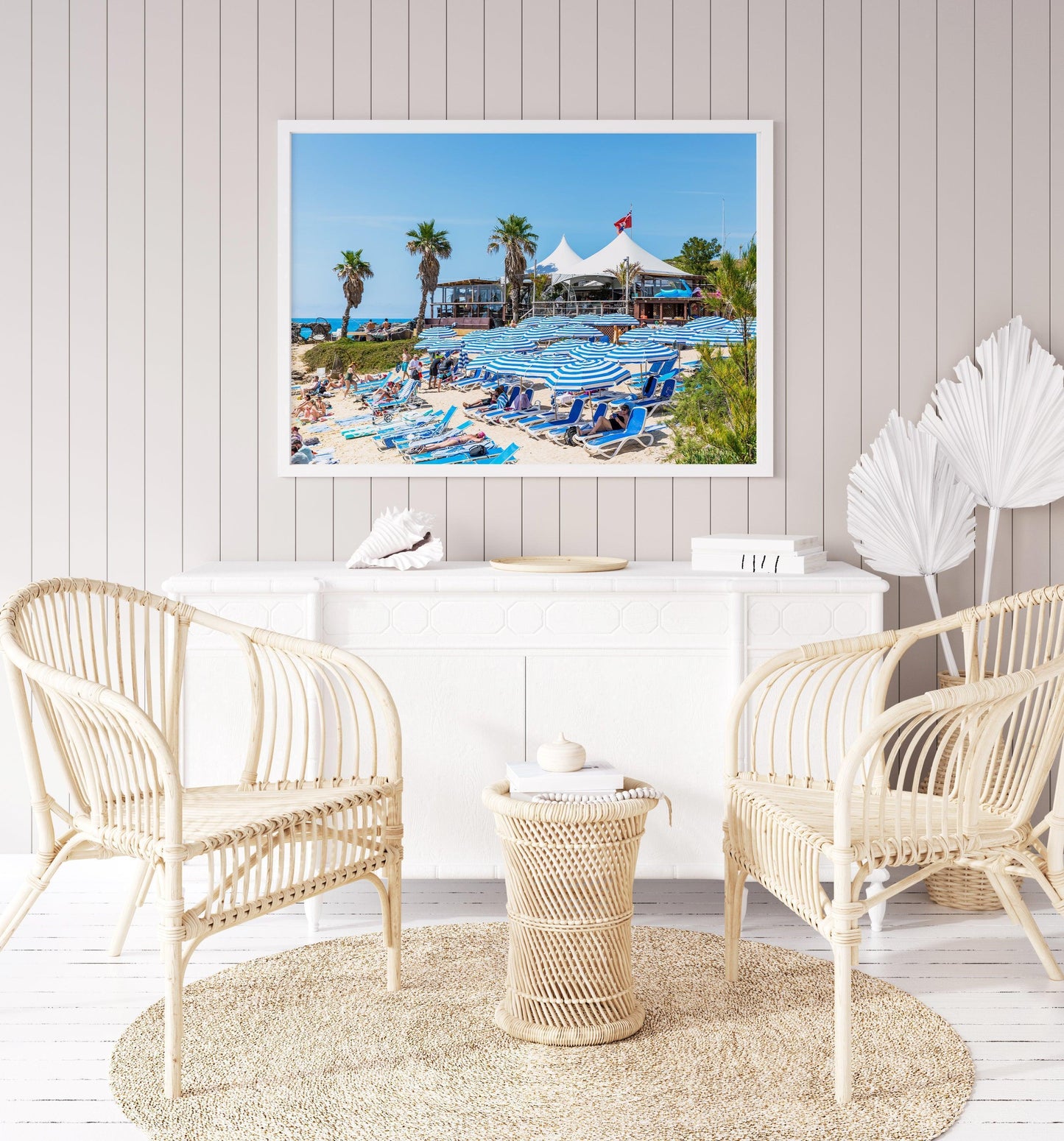 Blue beach umbrellas along the shoreline of Tobacco Bay, Bermuda, with turquoise waters in the background.