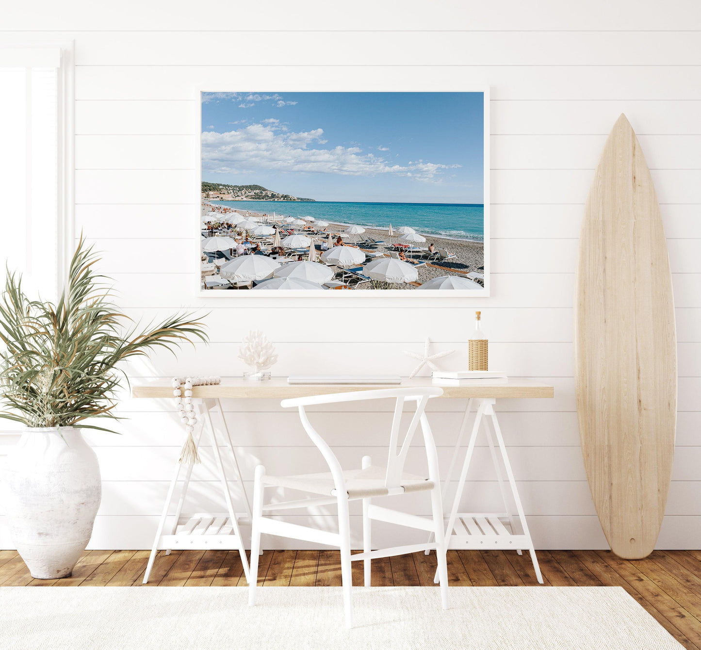 Nice, France beach umbrella print featuring white umbrellas along the coast. Coastal French Riviera wall art in horizontal format, ideal for bright and modern interiors.