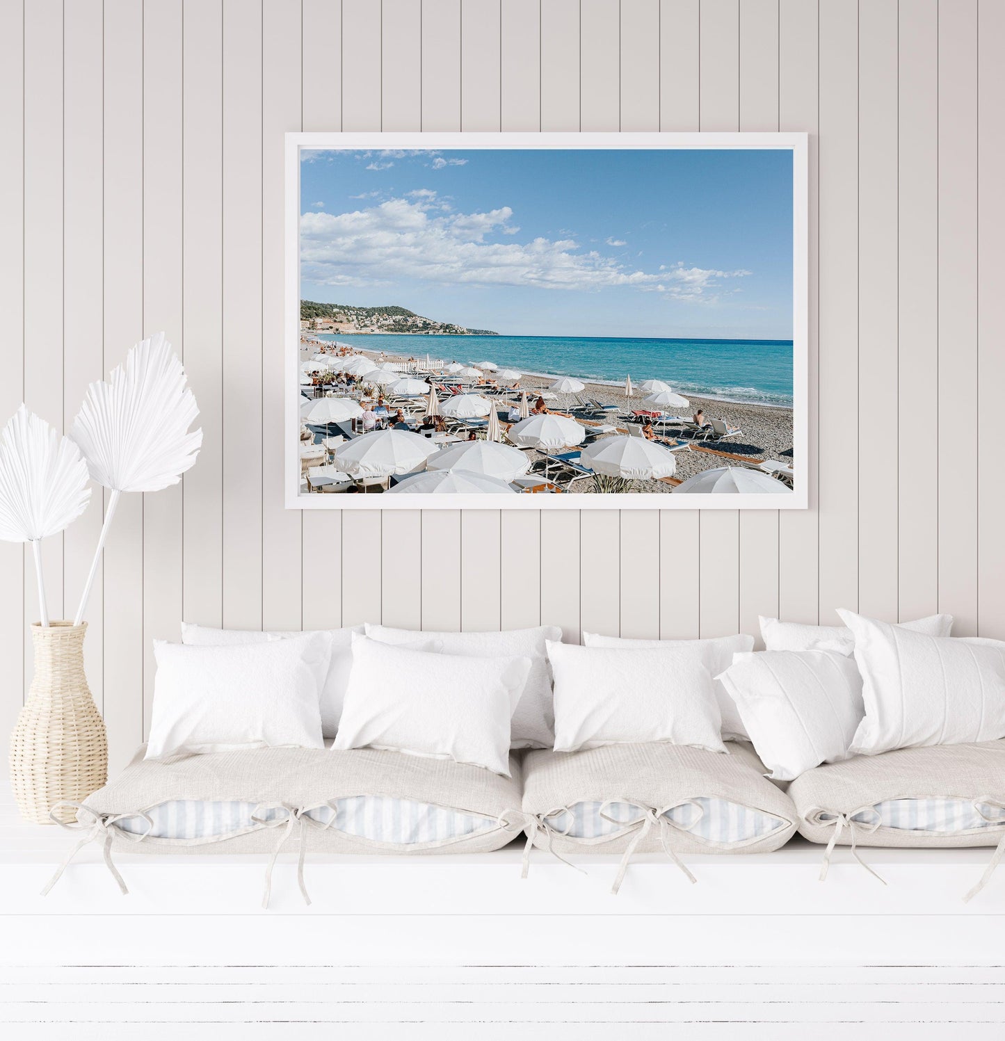 Nice, France beach umbrella print featuring white umbrellas along the coast. Coastal French Riviera wall art in horizontal format, ideal for bright and modern interiors.