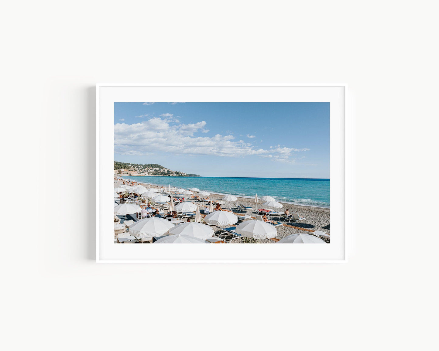 Nice, France beach umbrella print featuring white umbrellas along the coast. Coastal French Riviera wall art in horizontal format, ideal for bright and modern interiors.