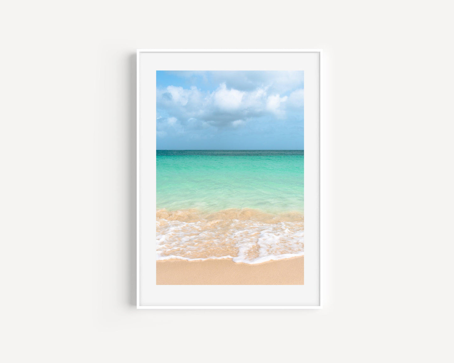 Vibrant ocean waves at Eagle Beach, Aruba with clear turquoise water and soft golden sand under a bright sky — colorful beach photography perfect for tropical and modern coastal decor.