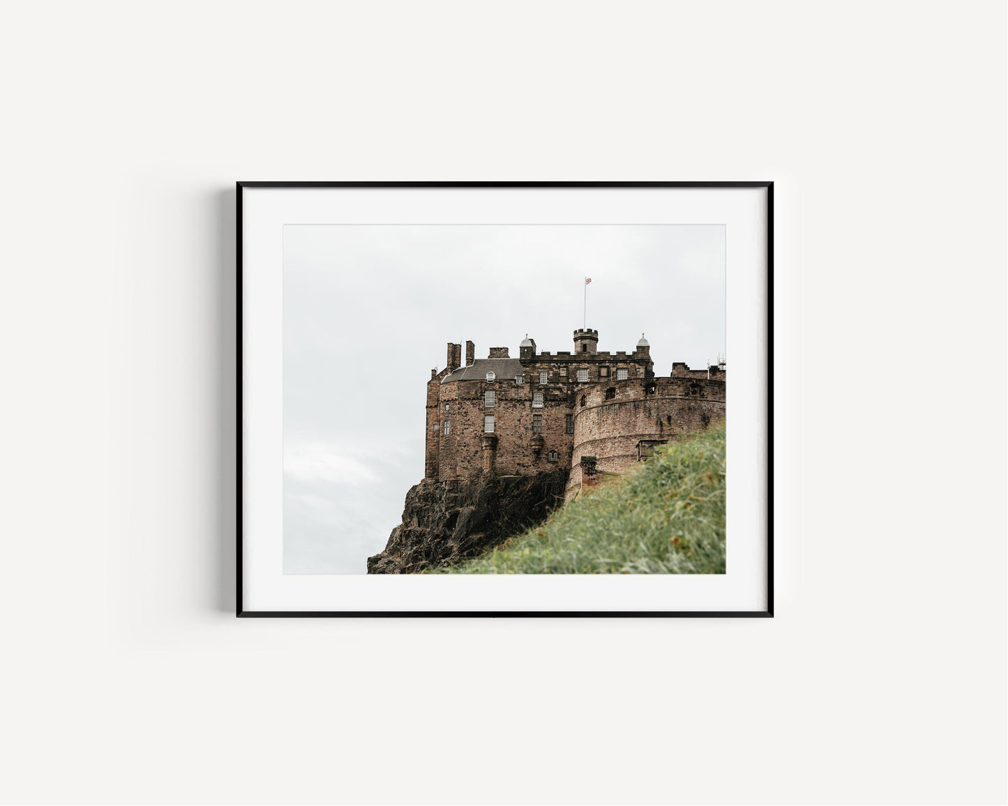 Horizontal photo of Edinburgh Castle in Scotland with stone walls, turrets, and cloudy sky – historic architecture print