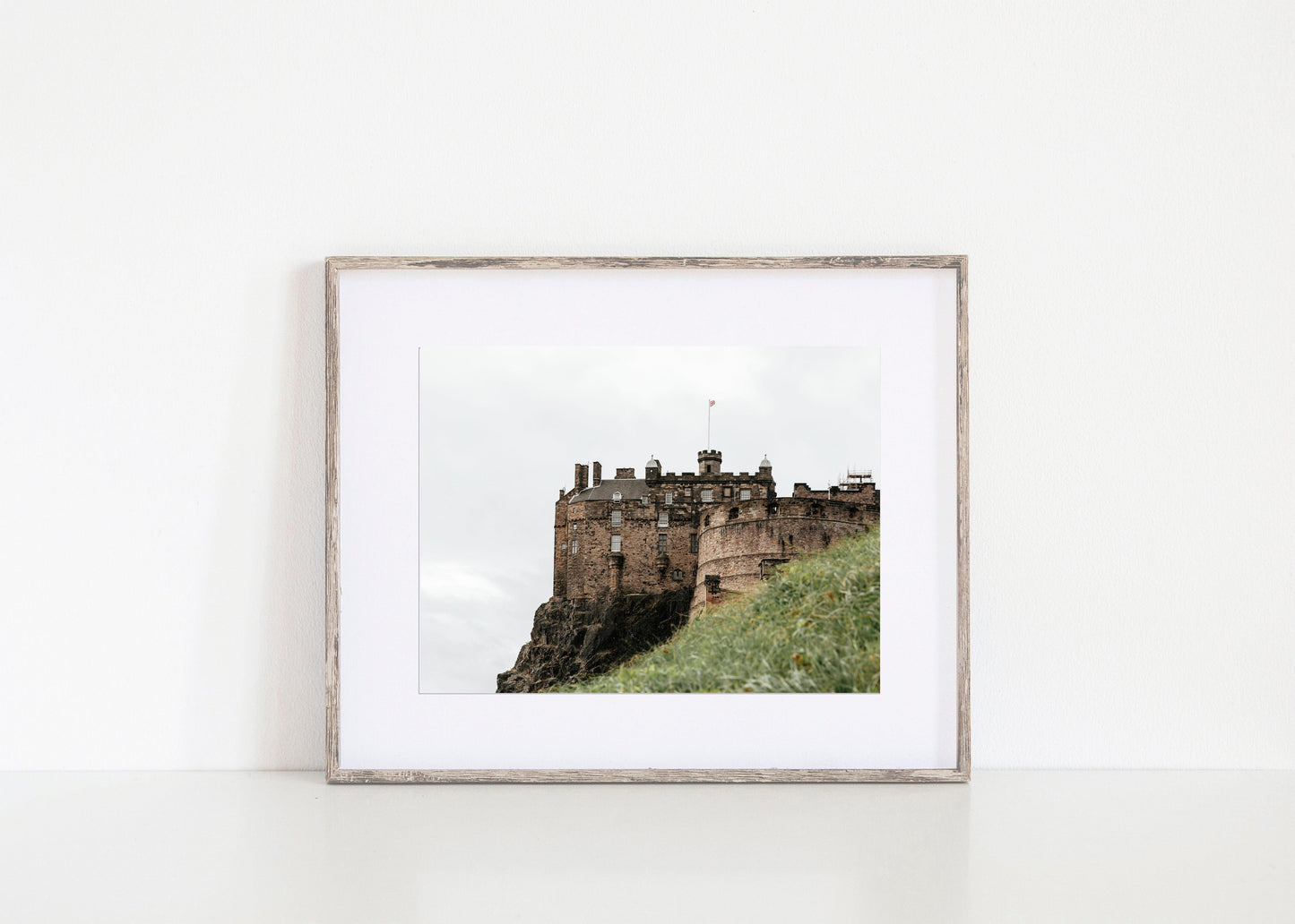 Horizontal photo of Edinburgh Castle in Scotland with stone walls, turrets, and cloudy sky – historic architecture print