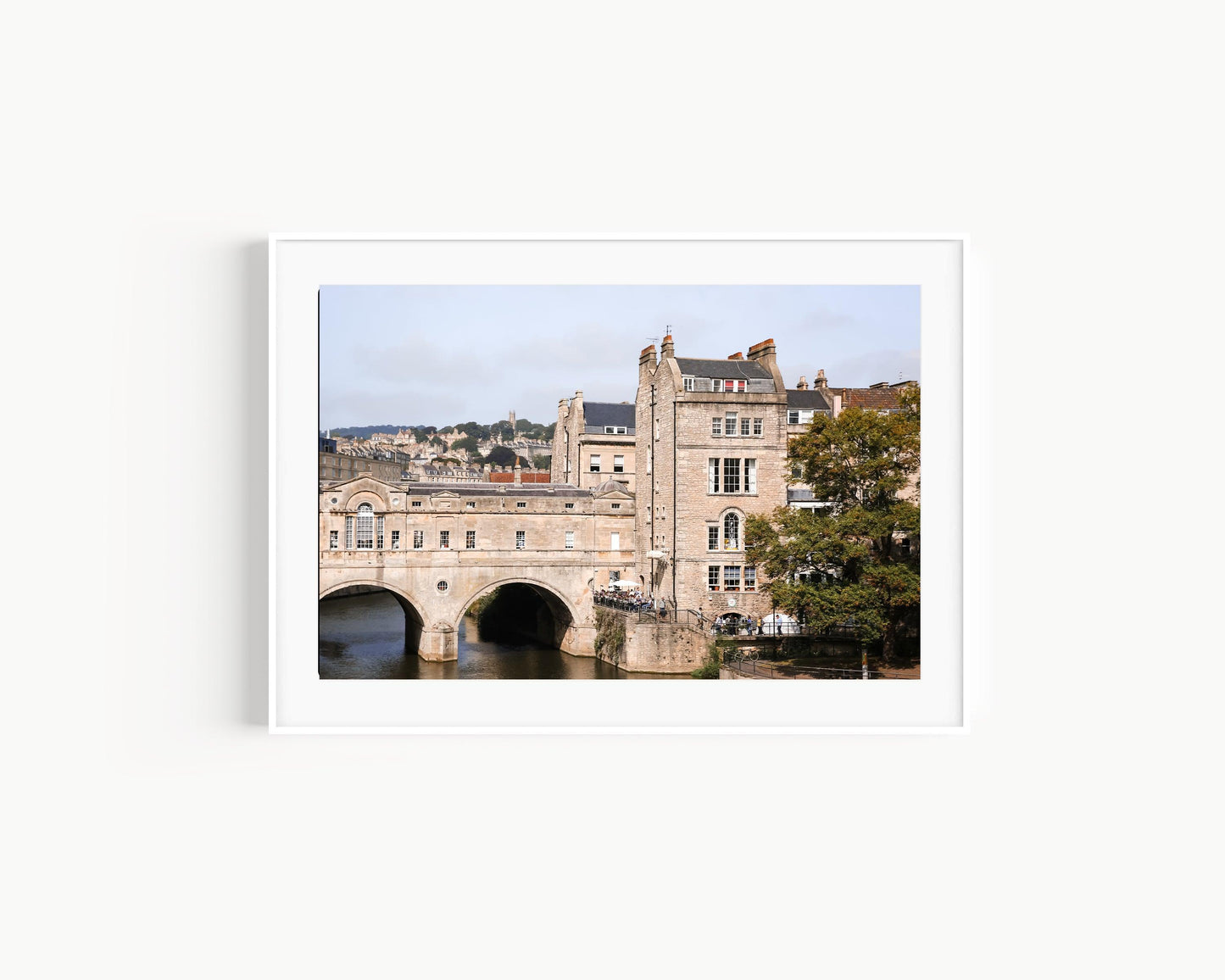 Color photograph of Pulteney Bridge in Bath, England, with historic stone buildings and the River Avon