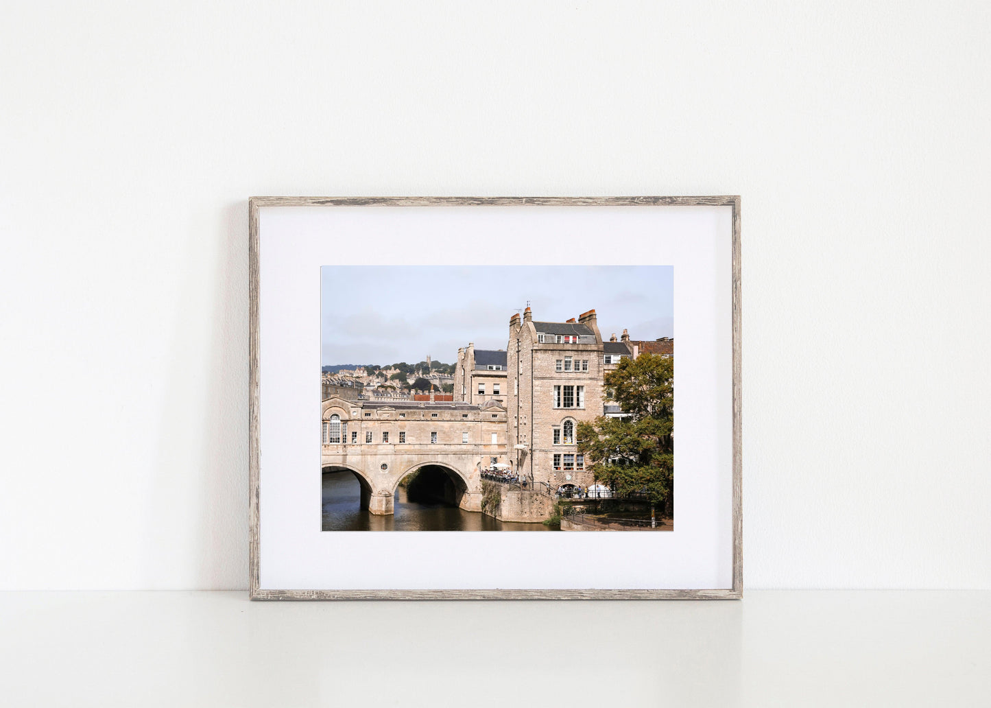 Color photograph of Pulteney Bridge in Bath, England, with historic stone buildings and the River Avon