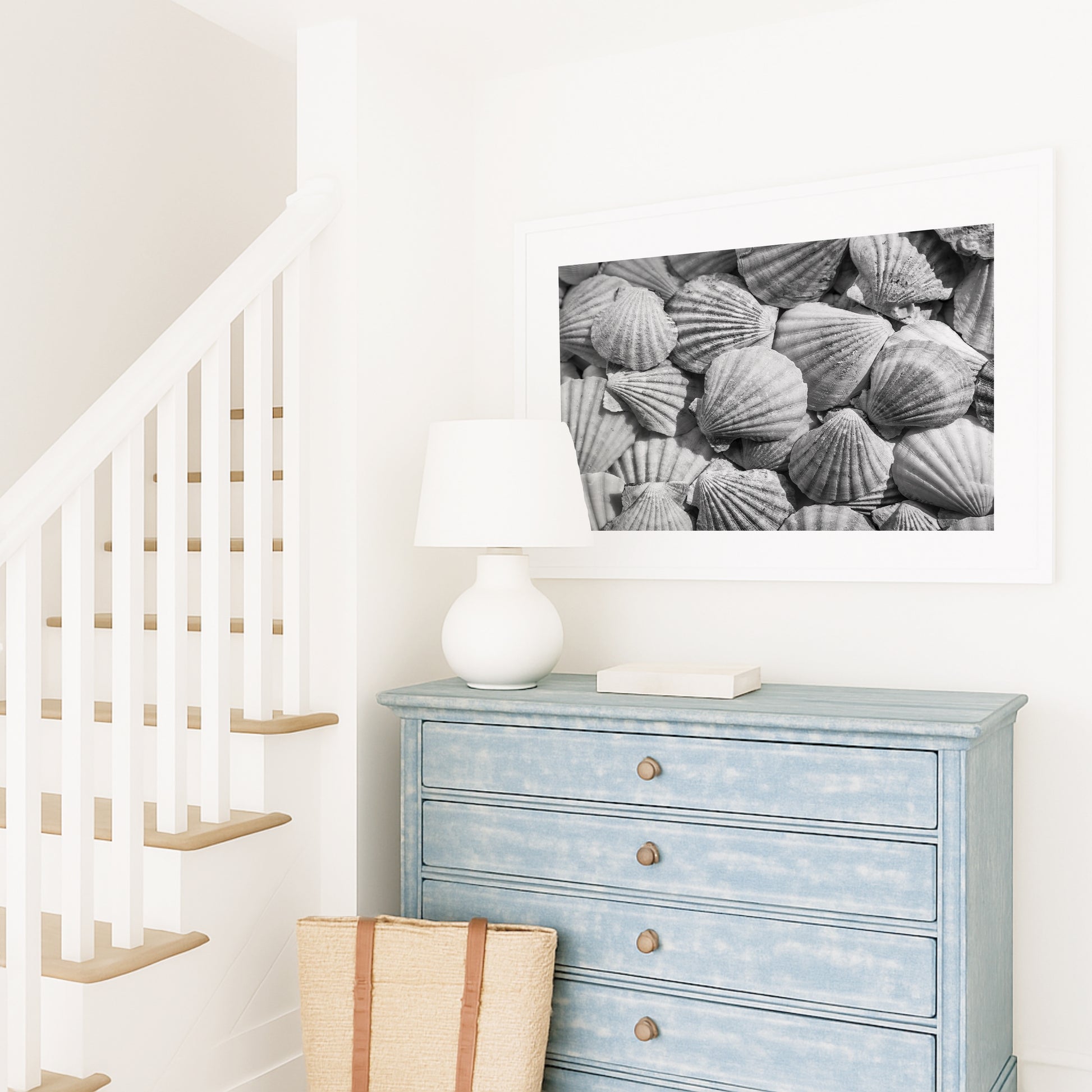 Black and white photograph of seashells arranged closely, creating a textured coastal wall art print.