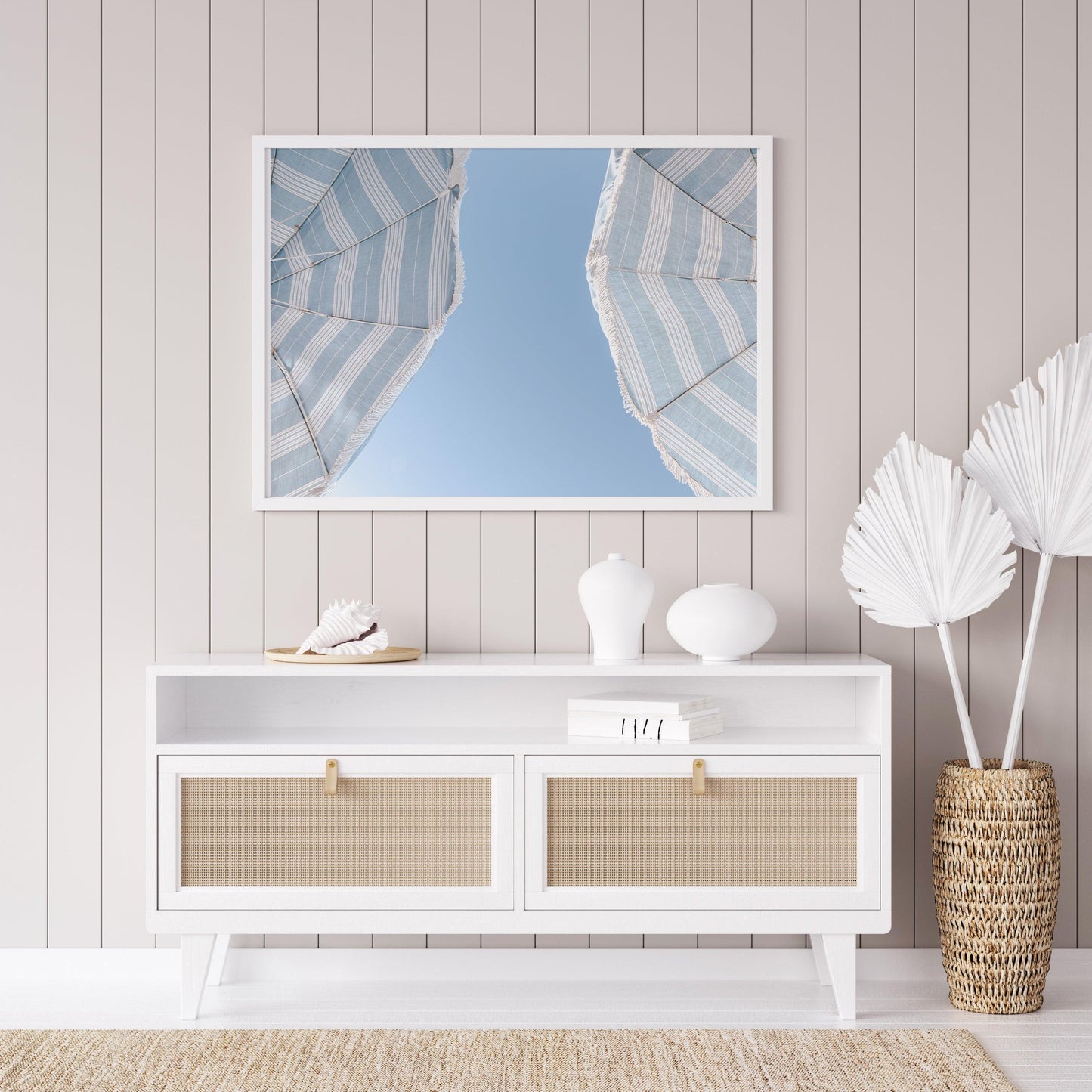 Blue striped beach umbrellas against a clear sky – horizontal coastal summer print
