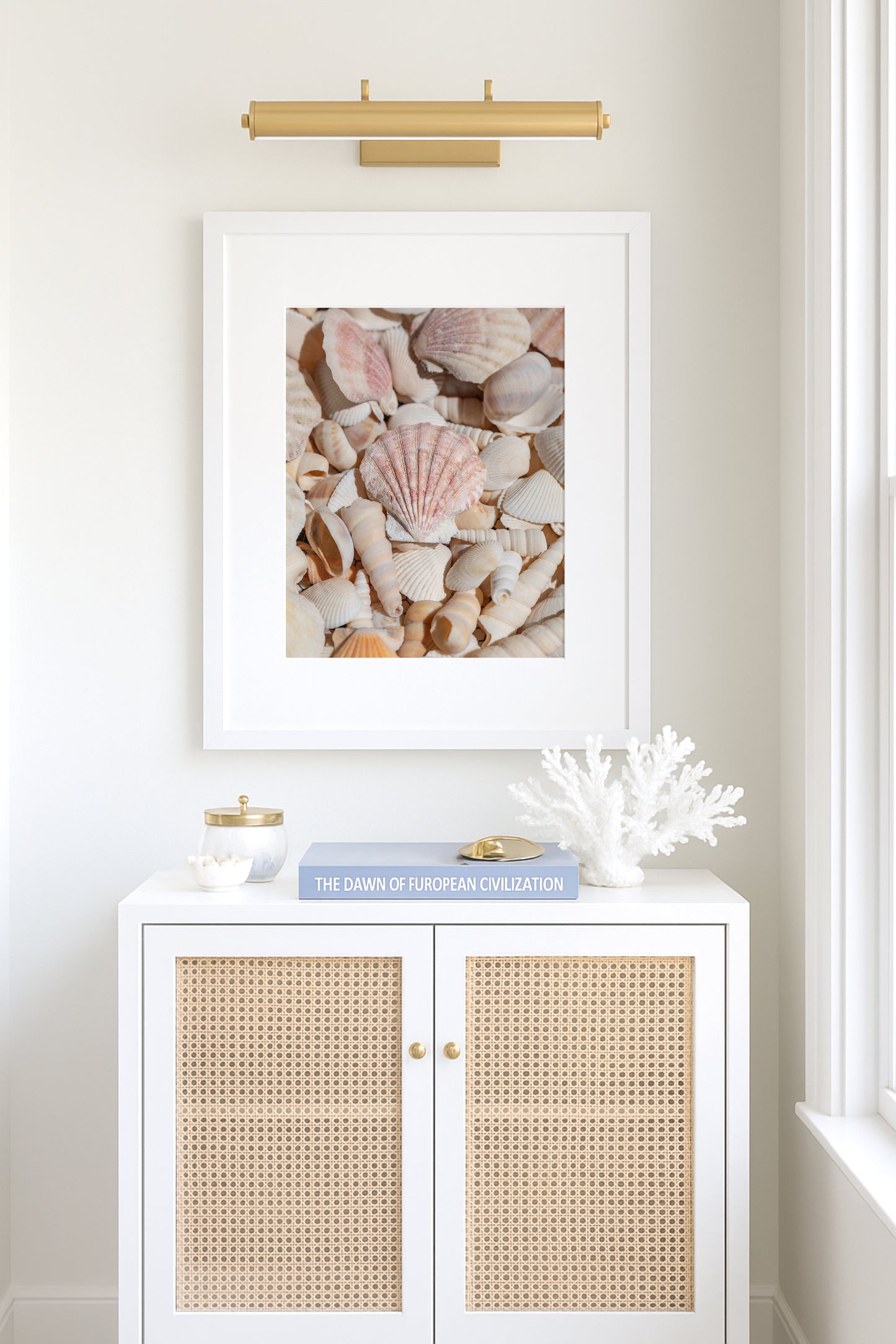Vertical photograph of neutral-toned seashells with soft lighting and pastel shades — coastal wall art with a minimalist beach house aesthetic.