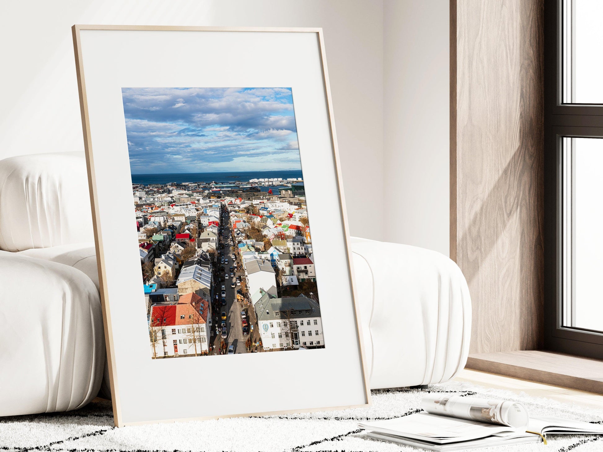 Colorful Reykjavik skyline on a clear day, showing a Nordic cityscape with vibrant rooftops, downtown buildings, and the North Atlantic in the background. Vertical Iceland photography print.