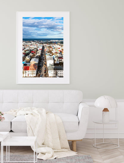 Colorful Reykjavik skyline on a clear day, showing a Nordic cityscape with vibrant rooftops, downtown buildings, and the North Atlantic in the background. Vertical Iceland photography print.