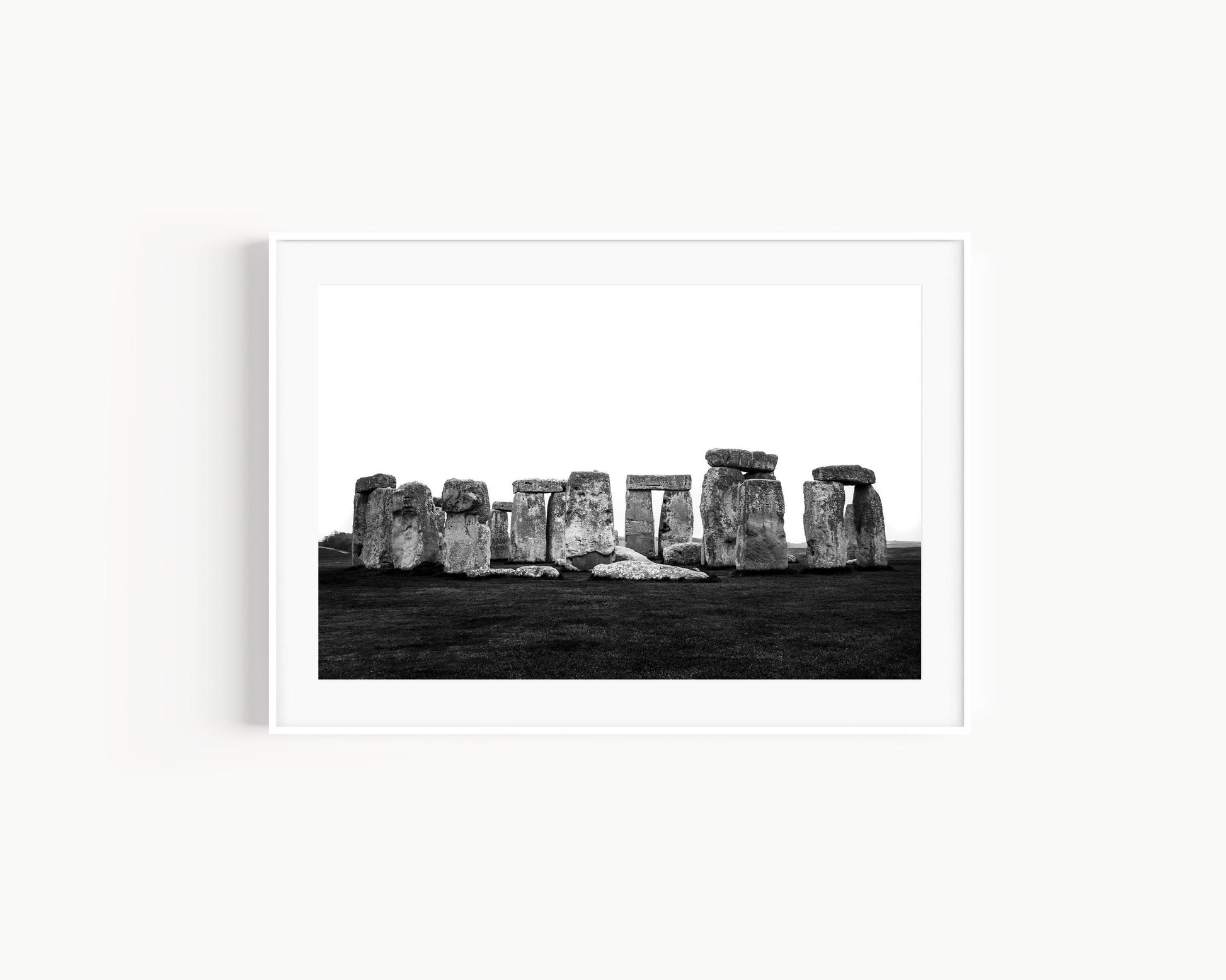 Black and white horizontal photo of Stonehenge with ancient stones against a cloudy sky – minimal neutral wall art
